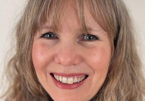 Smiling woman with blonde hair and blue eyes close-up portrait
