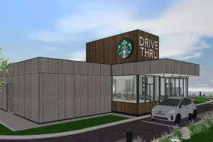 Rendering of a modern drive-thru coffee shop with car in queue, branded exterior signage under clear blue sky