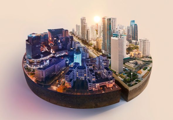 A panoramic view of a vibrant cityscape featuring modern skyscrapers and urban architecture under a clear blue sky